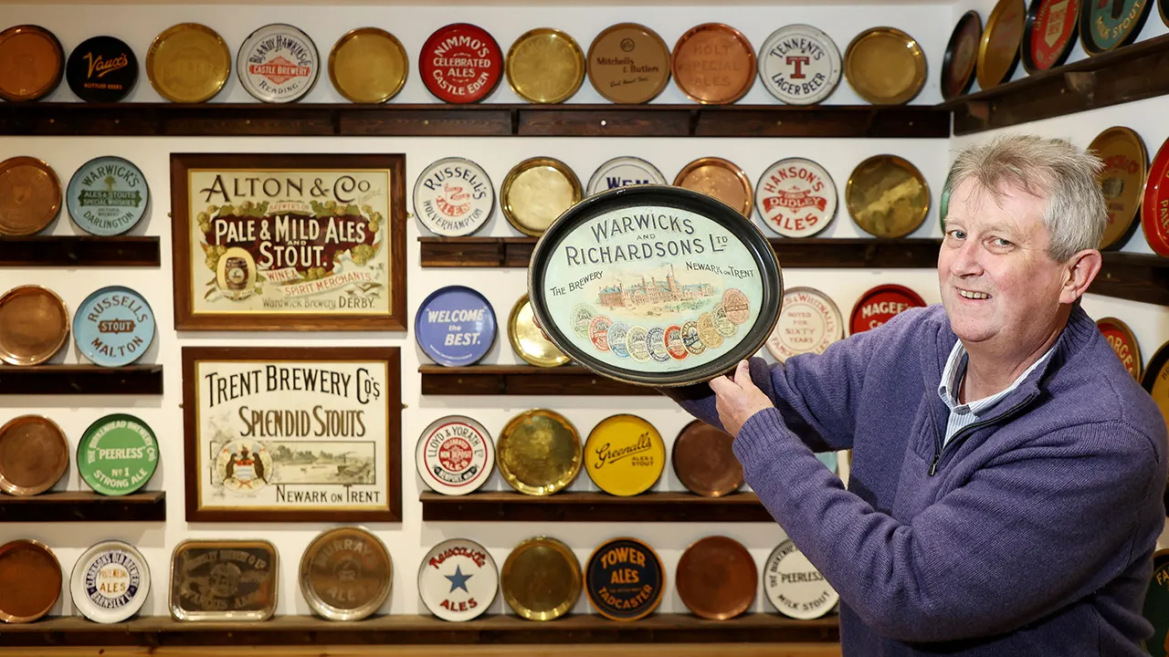 Man collects and preserves brewing history with 1,500 beer trays in his home